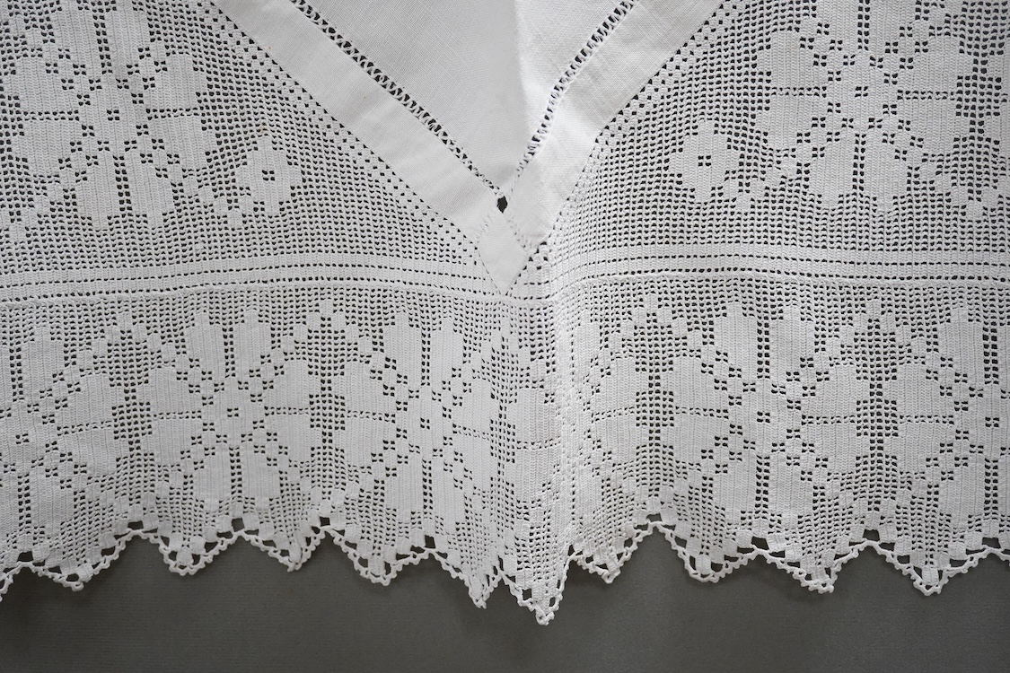 Two boxes of mixed white on white embroidered linen and cotton table cloths etc, some with crochet edging and cut work.